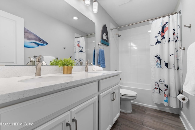 full bathroom with shower / tub combo, vanity, hardwood / wood-style flooring, and toilet