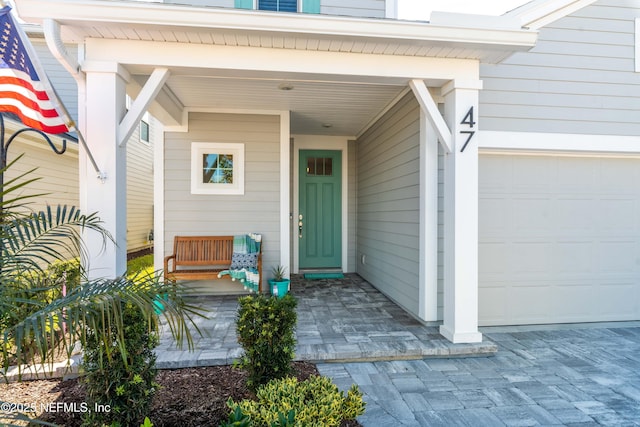 view of exterior entry with a garage