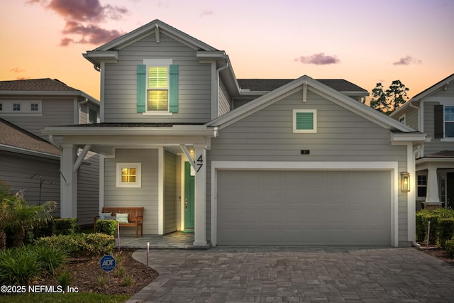 traditional-style house featuring driveway and an attached garage
