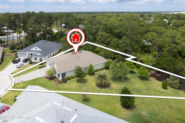 birds eye view of property with a forest view