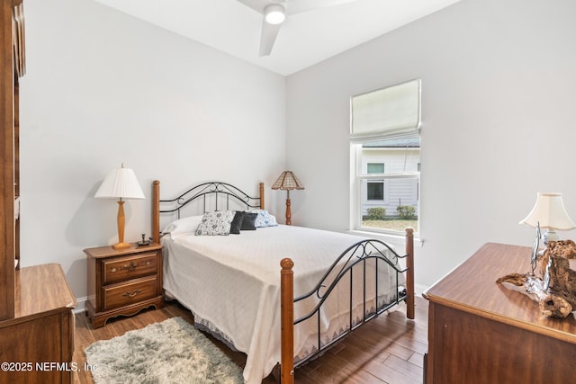 bedroom featuring a ceiling fan, baseboards, and wood finished floors