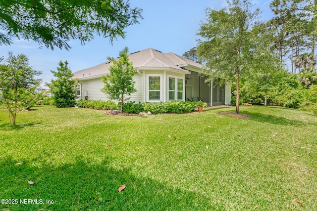 exterior space with a lawn and a sunroom