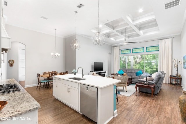 kitchen with a sink, visible vents, white cabinets, open floor plan, and appliances with stainless steel finishes