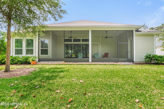 rear view of house featuring a lawn, a sunroom, and a ceiling fan