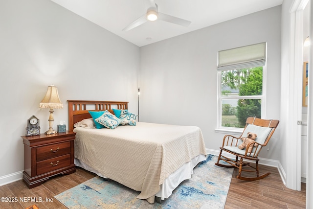 bedroom with wood finished floors, a ceiling fan, and baseboards