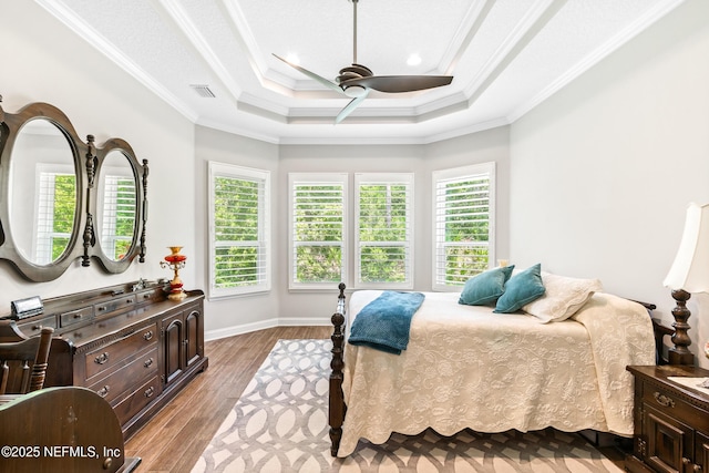 bedroom with ornamental molding, multiple windows, visible vents, and light wood finished floors