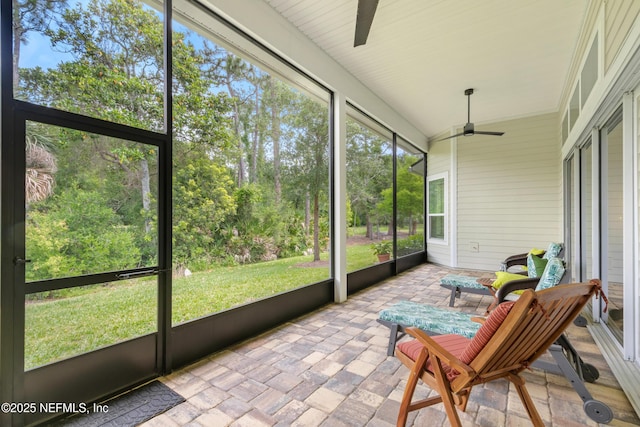 sunroom / solarium featuring a ceiling fan