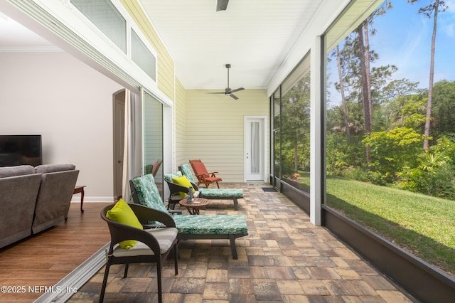 sunroom featuring a ceiling fan