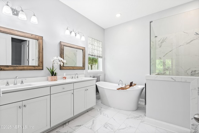 full bathroom with a soaking tub, a sink, marble finish floor, and double vanity