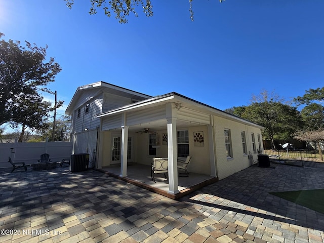 view of side of home with central AC, a patio, and ceiling fan