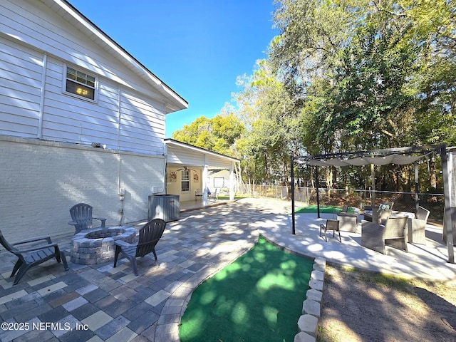 view of patio featuring an outdoor living space with a fire pit and central air condition unit