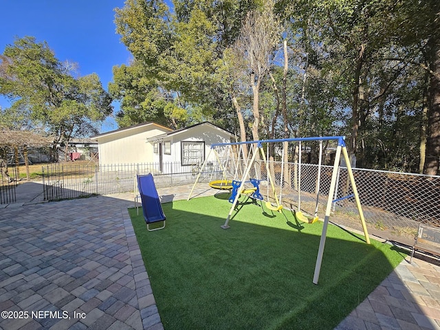 view of jungle gym featuring a lawn