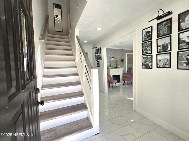 stairway featuring a textured ceiling