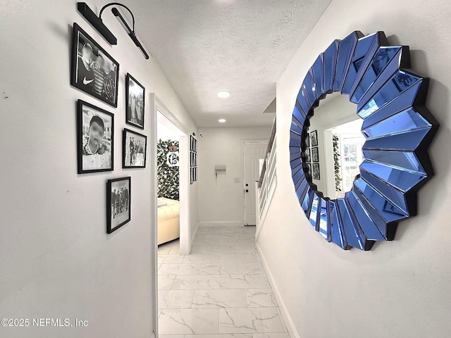 corridor featuring a textured ceiling