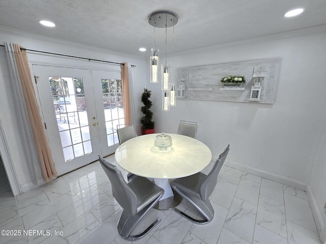 dining area with ornamental molding, french doors, and a textured ceiling