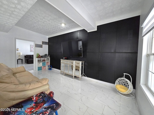 living room with beam ceiling and a textured ceiling