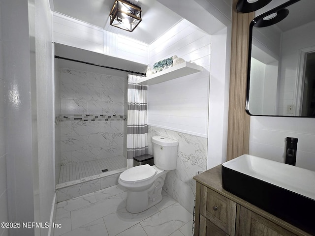 bathroom featuring walk in shower, vanity, toilet, and tile walls