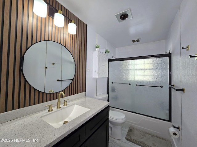 full bathroom featuring vanity, toilet, and combined bath / shower with glass door