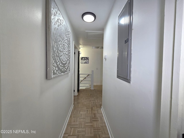 corridor with parquet flooring and electric panel