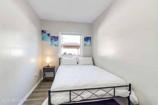 bedroom with dark hardwood / wood-style floors