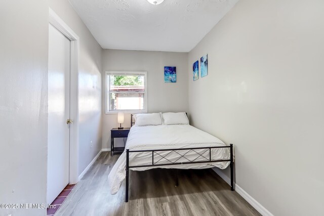 bedroom with wood-type flooring