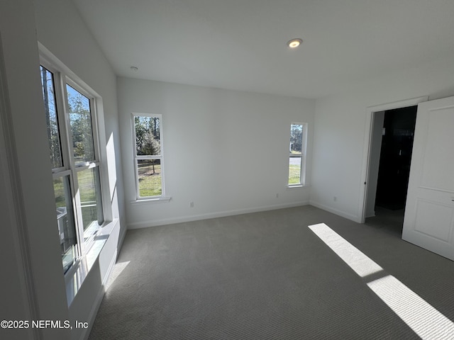 unfurnished room featuring dark carpet