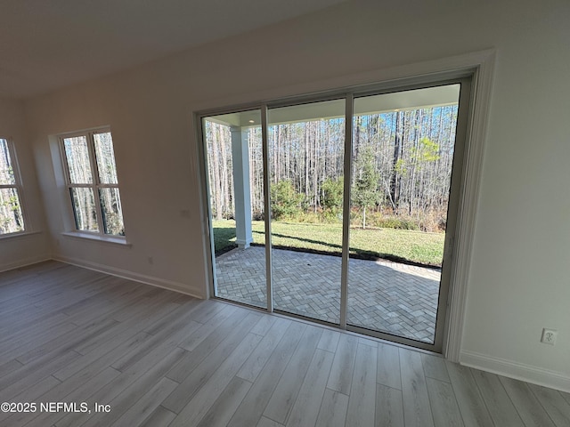 doorway with light hardwood / wood-style flooring