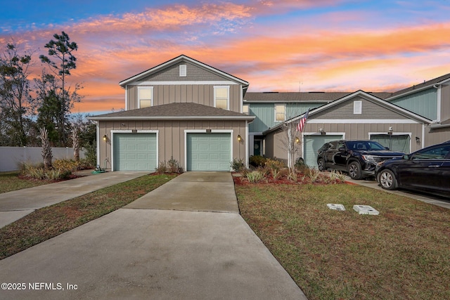 front of property with a garage and a yard