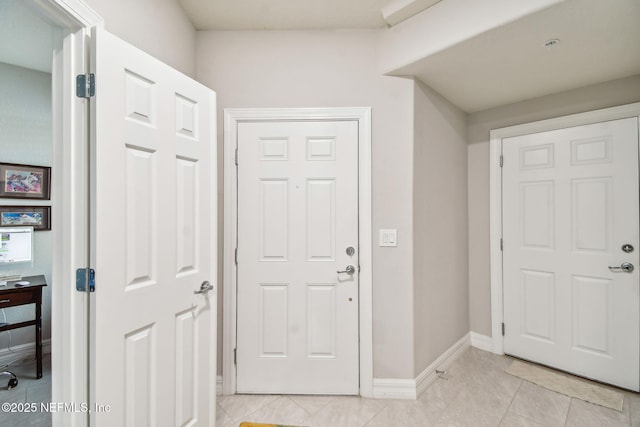 foyer featuring light tile patterned flooring