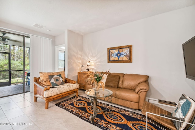 tiled living room featuring baseboard heating