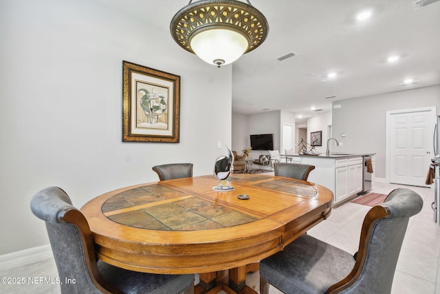 tiled dining room with sink