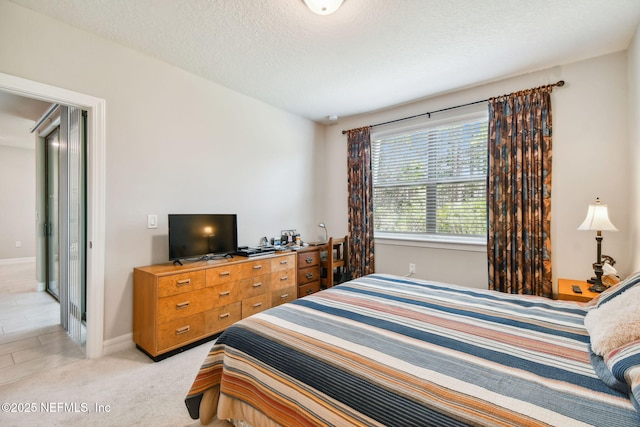 carpeted bedroom with a textured ceiling