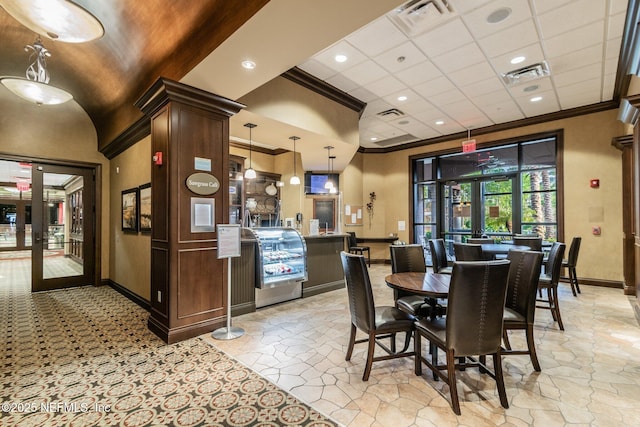 interior space with ornamental molding and french doors