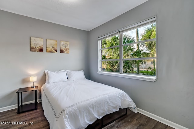 bedroom with dark wood-type flooring