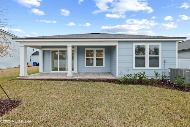 back of house with a yard, central air condition unit, and a patio area