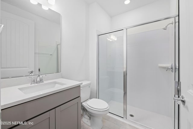 bathroom featuring walk in shower, vanity, and toilet