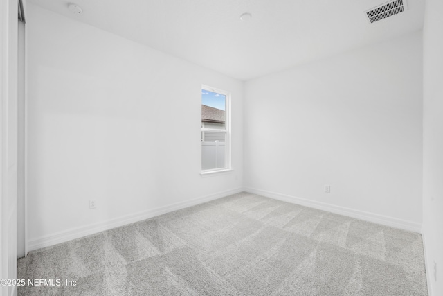 empty room featuring light colored carpet