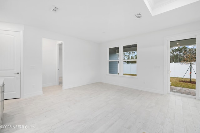 unfurnished room with light hardwood / wood-style flooring and plenty of natural light