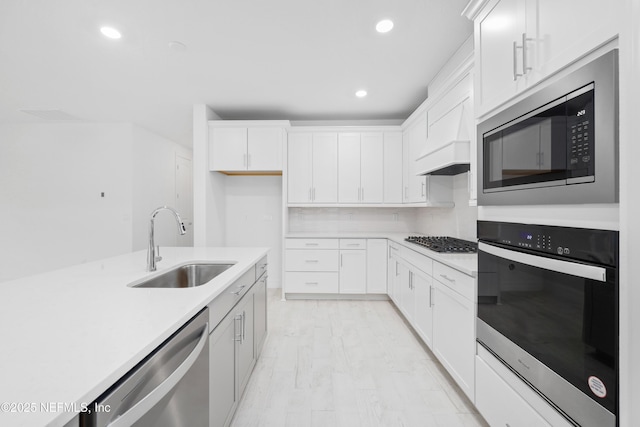 kitchen with white cabinetry, appliances with stainless steel finishes, and sink