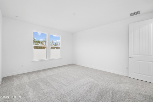 unfurnished room featuring light carpet