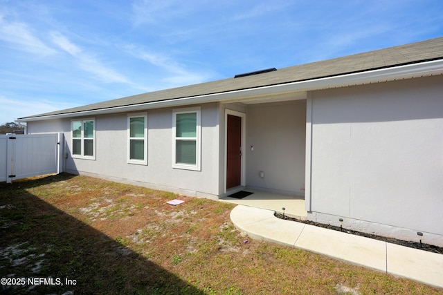 entrance to property featuring a yard