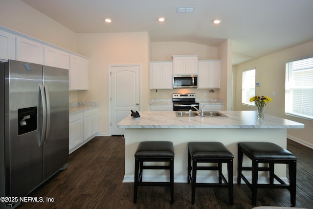 kitchen featuring sink, appliances with stainless steel finishes, a kitchen island with sink, white cabinetry, and dark hardwood / wood-style flooring