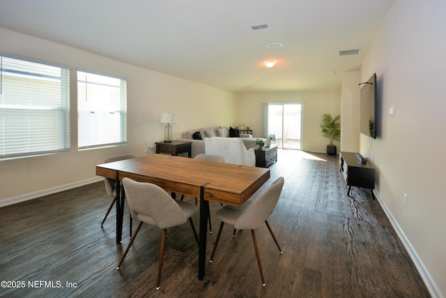 dining room with dark hardwood / wood-style flooring