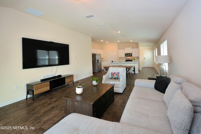 living room with dark wood-type flooring and vaulted ceiling