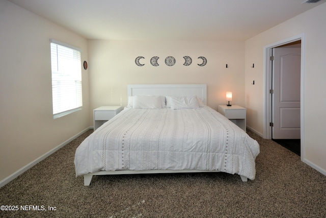 bedroom with dark colored carpet