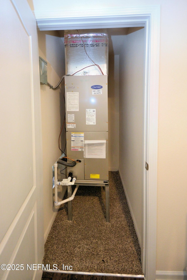 utility room featuring heating unit