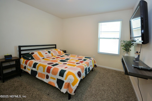 bedroom with multiple windows and dark colored carpet