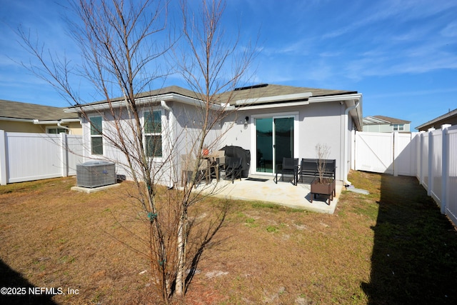 back of property featuring central AC, a patio area, and a lawn