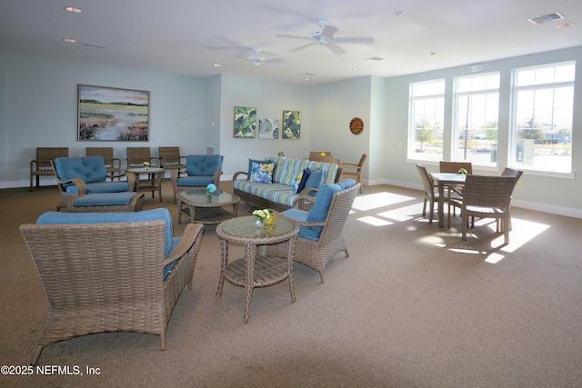 living room featuring carpet and ceiling fan