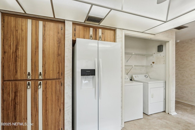 clothes washing area with separate washer and dryer